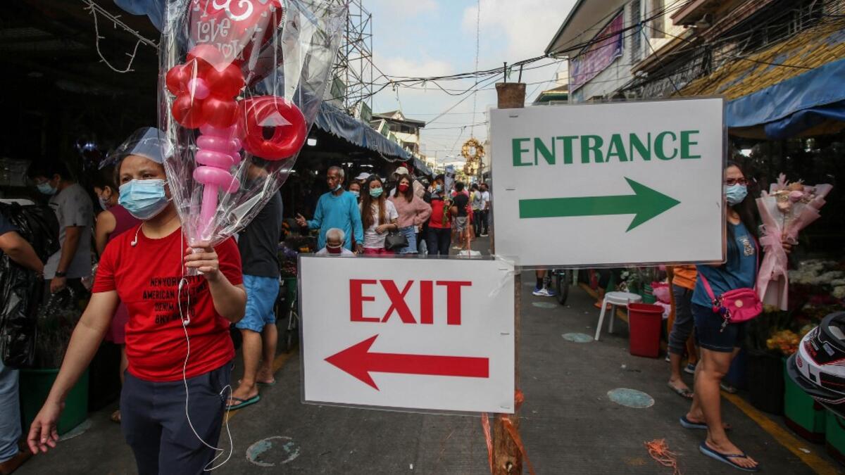 People buy flowers at a market in Manila on Valentine's Day on February 14, 2021. Jam STA ROSA / AFP