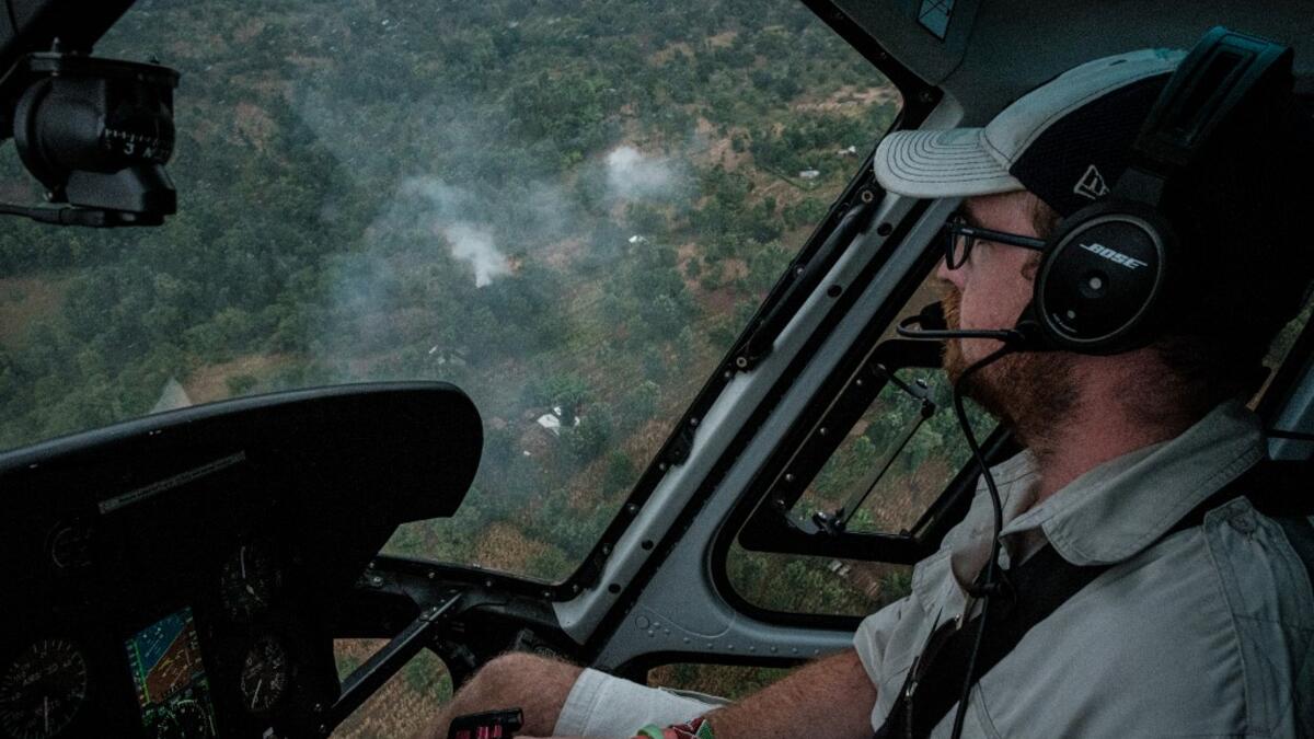 A picuture taken on February 8, 2021, shows a pilot following a swarm of desert locust during the surveillance flight as local farmers use fires to produce smoke to chase away locusts from their fields in Meru, Kenya. Yasuyoshi CHIBA / AFP