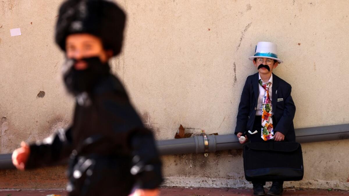 Israelis dressed in costumes in celebration of the Jewish holiday of Purim are pictured in the ultra-Orthodox neighborhood of Bnei Brak, on February 26, 2021. Israel imposed a night-time curfew for three nights from yesterday evening to curb the spread of the coronavirus during the Jewish holiday of Purim, the government said. The curfew, from 8:30 pm to 5:00 am daily (1830 GMT to 0300 GMT), will be in force from Thursday night until Sunday morning, a joint statement from the prime minister's office and the