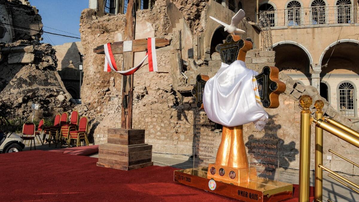 a view of (L to R) of Latin and Chaldean crosses placed upon a platform where Pope Francis is due to speak