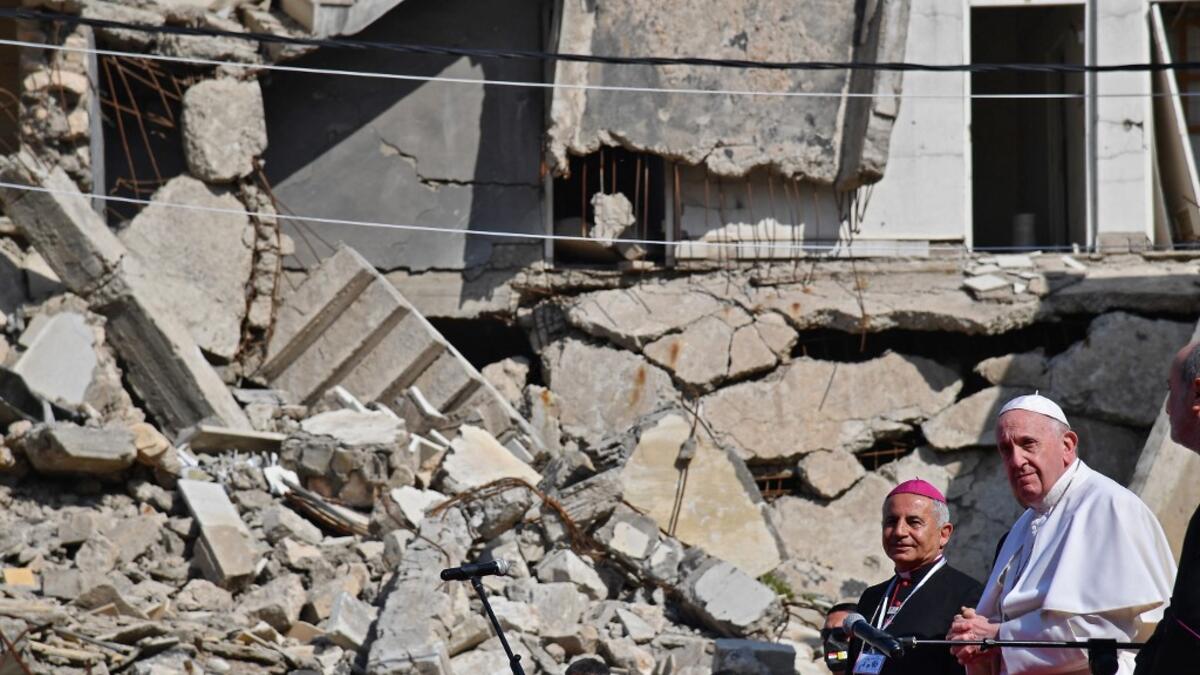 Pope Francis (R), accompanied by the Chaldean Catholic Archbishop of Mosul Najib Michaeel Moussa