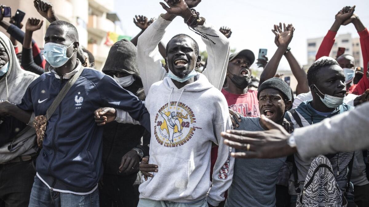 Supporters of main opposition candidate, Ousmane Sonko, gather in protest outside the Justice Palace calling for his release in Dakar on March 8, 2021. Protests have been ongoing after the Senegal opposition leader Ousmane Sonko was arrested following rape charges. JOHN WESSELS / AFP