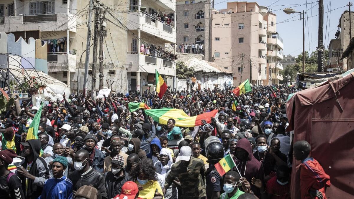 Supporters of main opposition candidate, Ousmane Sonko, react after Sonko was released from detention in Dakar on March 8, 2021. A Senegalese judge charged opposition leader Ousmane Sonko with rape and freed him from detention pending an investigation on March 8, 2021, after his arrest last week sparked the West African state's worst unrest in years. JOHN WESSELS / AFP
