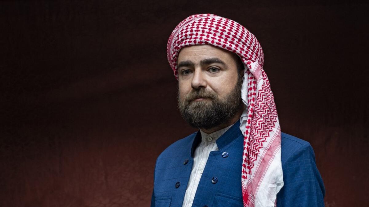 A Syrian Kurdish man in traditional attire poses for a picture during the yearly ceremony celebrating "Kurdish Clothing Day"
