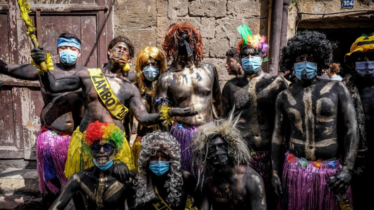 Carnival participants dressed in costume and wearing body paint pose for a group picture during the annual Zambo carnival held in Lebanon