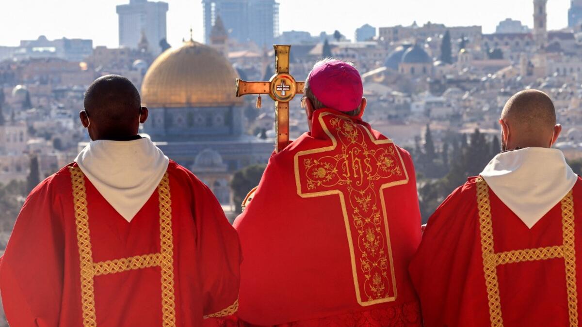 Latin Patriarch of Jerusalem Pierbattista Pizzaballa (C) holds a prayer during a Palm Sunday