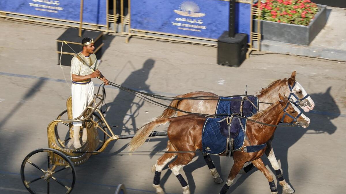 A re-enactor dressed in costume rides a two-horse chariot in Tahrir Square, in the centre of Egypt's capital Cairo