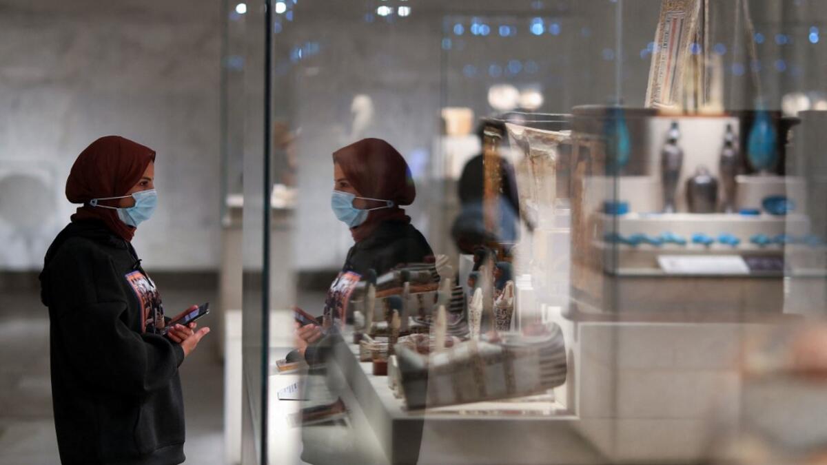A visitor looks at displayed artifacts at Egypt's new National Museum of Egyptian Civilisation (NMEC)