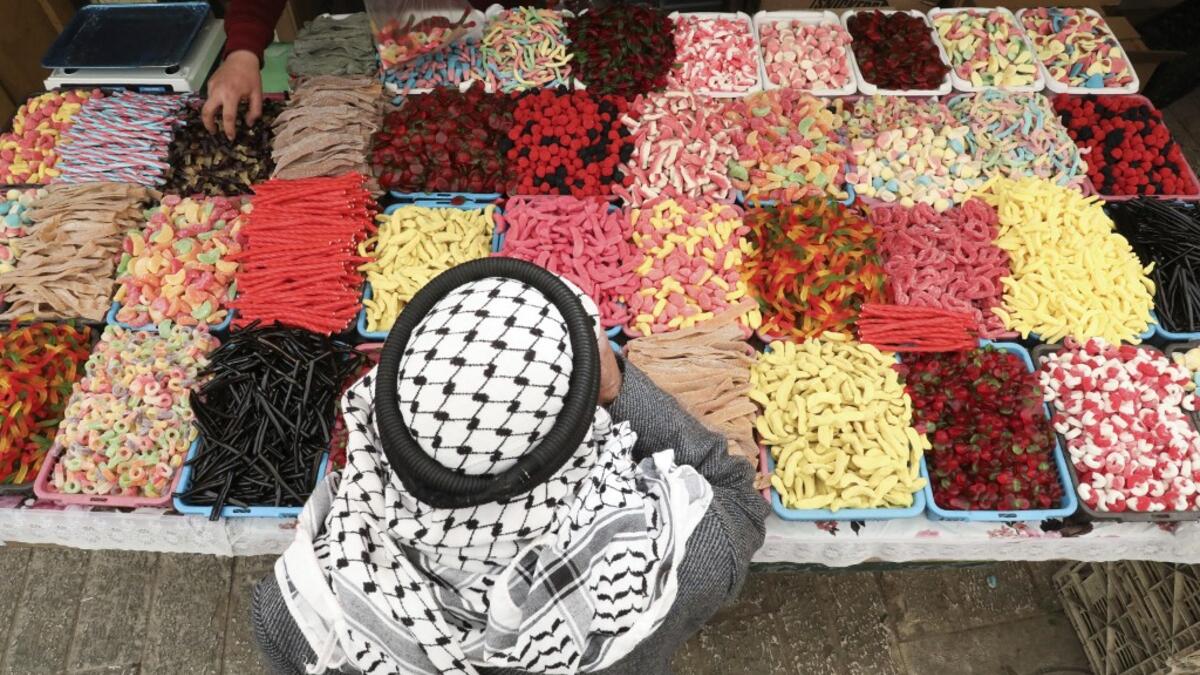 A Palestinian street vendor sells candy and sweets in Hebron's Old City in the Israeli-occupied West Bank