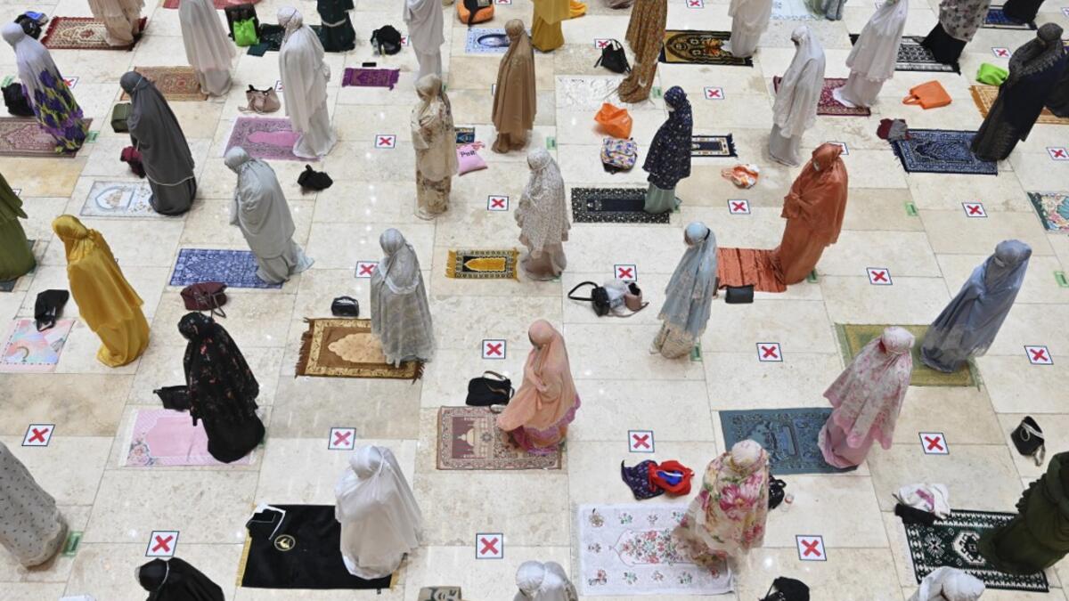Muslim women offer prayers on the first night of Ramadan
