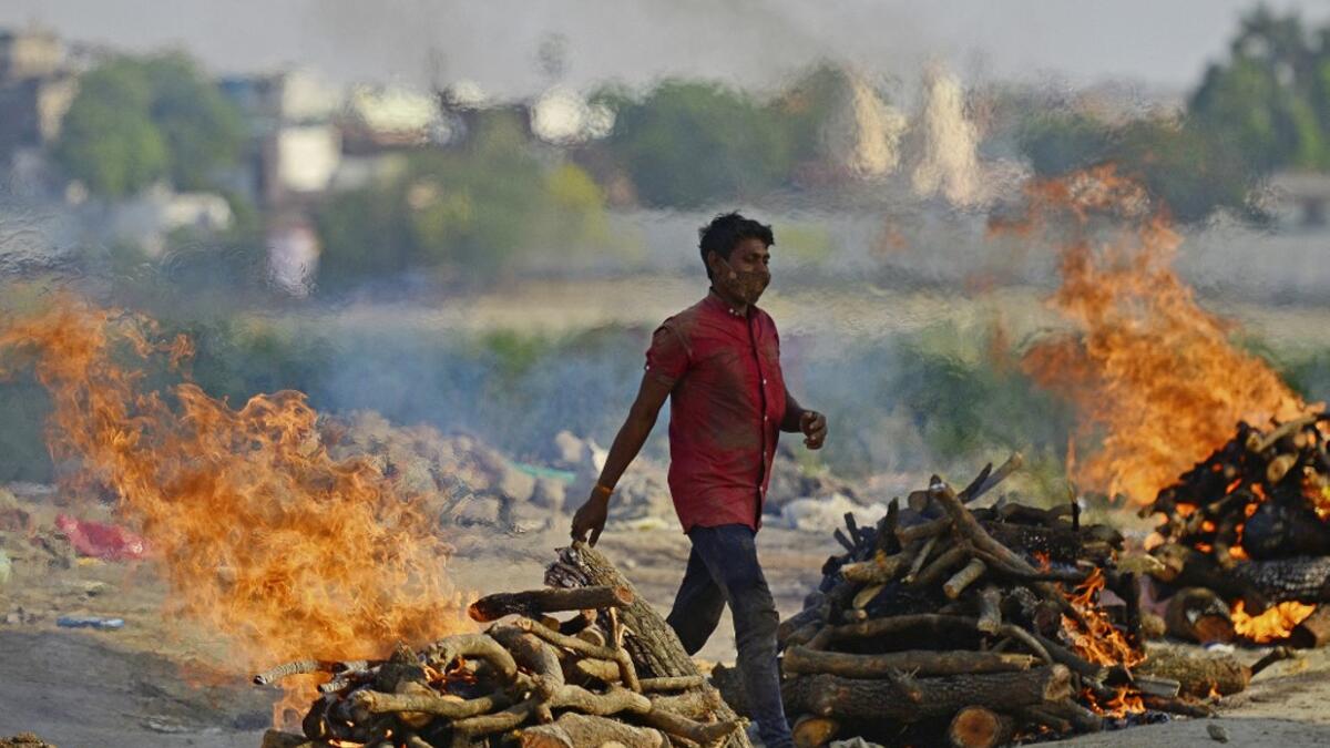 Funeral pyres burn as the last rites are performed of the patients who died of the Covid-19 coronavirus at a cremation ground in Allahabad