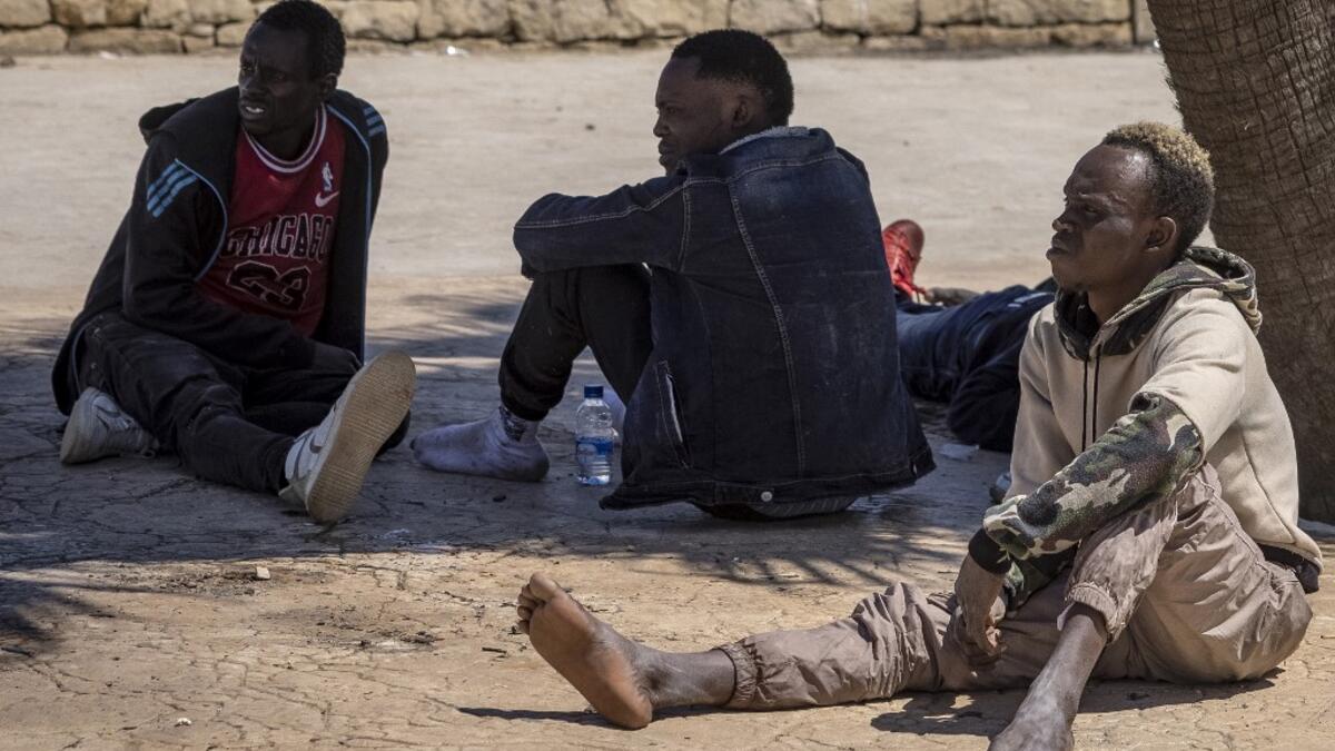 Subsaharian migants wait near the sea in the northern town of Fnideq as they attempt to cross the border from Morocco to Spain's North African enclave of Ceuta on May 19, 2021. Spain stepped up diplomatic pressure on Rabat as its prime minister flew into Ceuta, vowing to "restore order" in the North African enclave after a record 8,000 migrants reached its beaches from Morocco