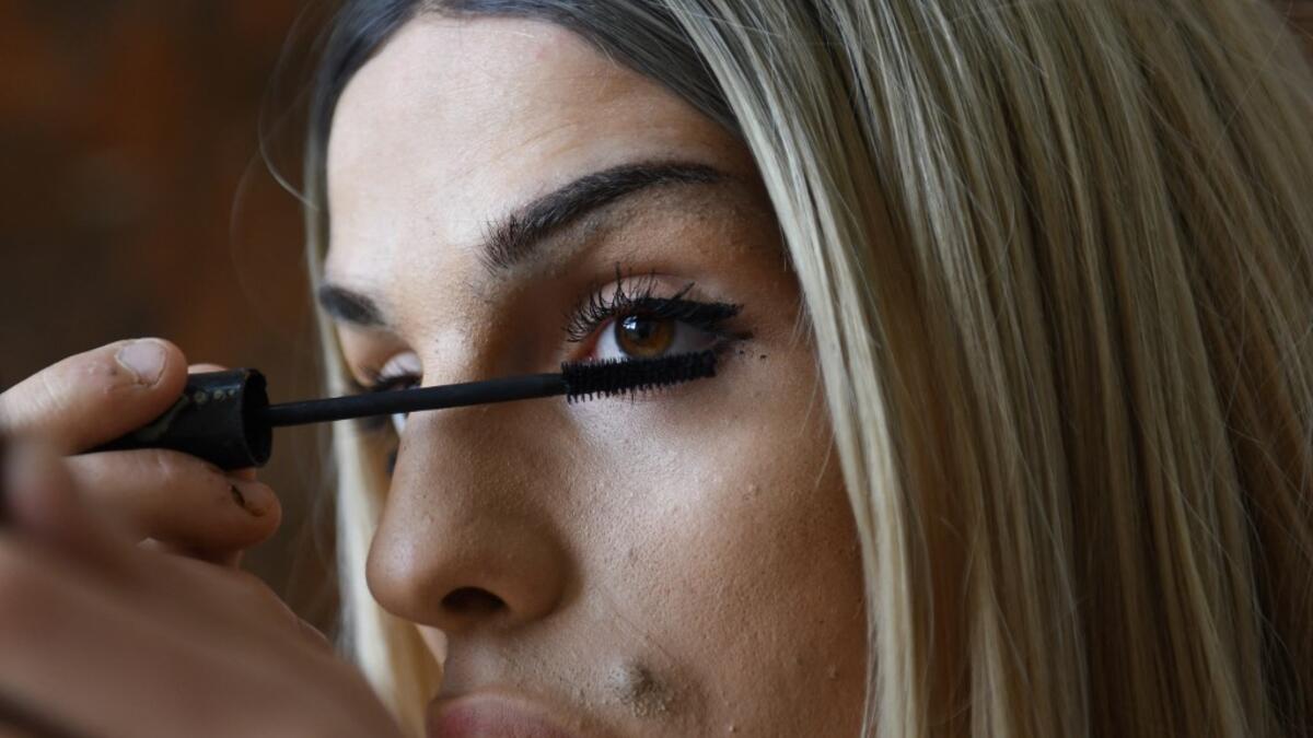Albanian transgender Denisa, puts her makeup on, in the former Communist-era maximum security prison for political prisoners in Spac