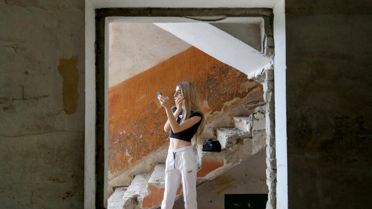 Albanian transgender Denisa, puts her makeup on, in the former Communist-era maximum security prison for political prisoners in Spac
