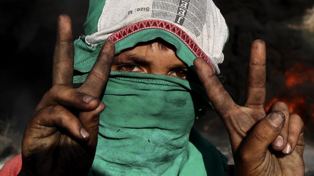Palestinians burn tires during demonstrations against the expansion of the Jewish settlement outpost of Eviatar, on the lands of Beita village, near the occupied West Bank city of Nablus