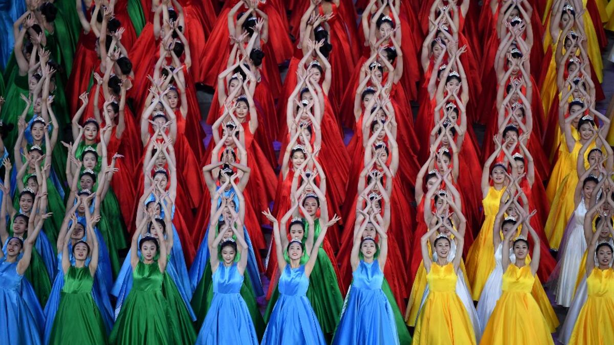 Performers dance as they take part in a Cultural Performance as part of the celebration of the 100th Anniversary of the Founding of the Communist Party of China, at the Bird's nest national stadium in Beijing on June 28, 2021. The 100th anniversary is scheduled