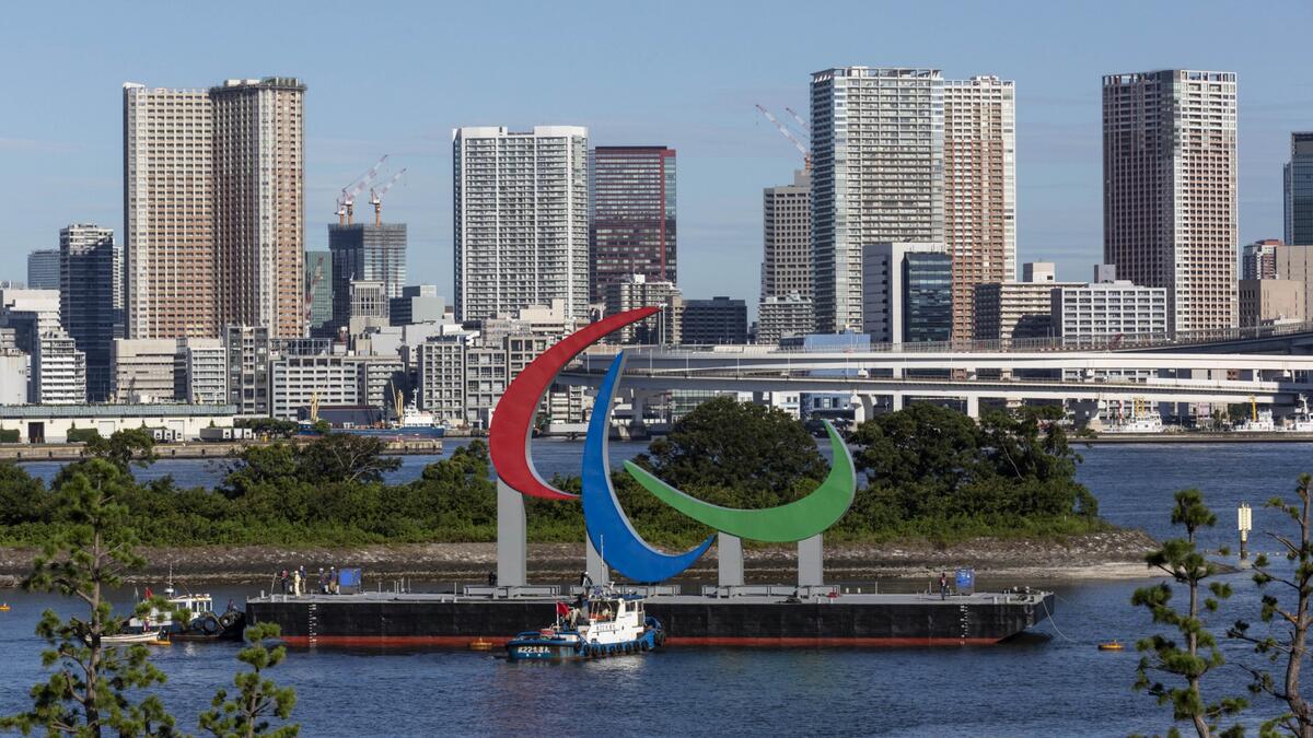 The Paralympic Symbol "the three agitos", 23.4m wide and 17.5m high, is brought by a salvage barge to install at the Tokyo waterfront in the waters of Odaiba Marine Park on August 20, 2021, four days before the opening of the Tokyo 2020 Paralympic Games.