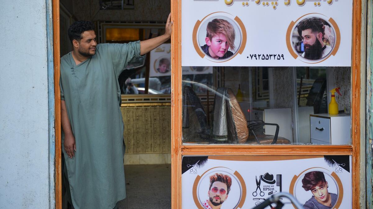 In this picture taken on September 19, 2021, a barber waits for customers at his shop in Herat.