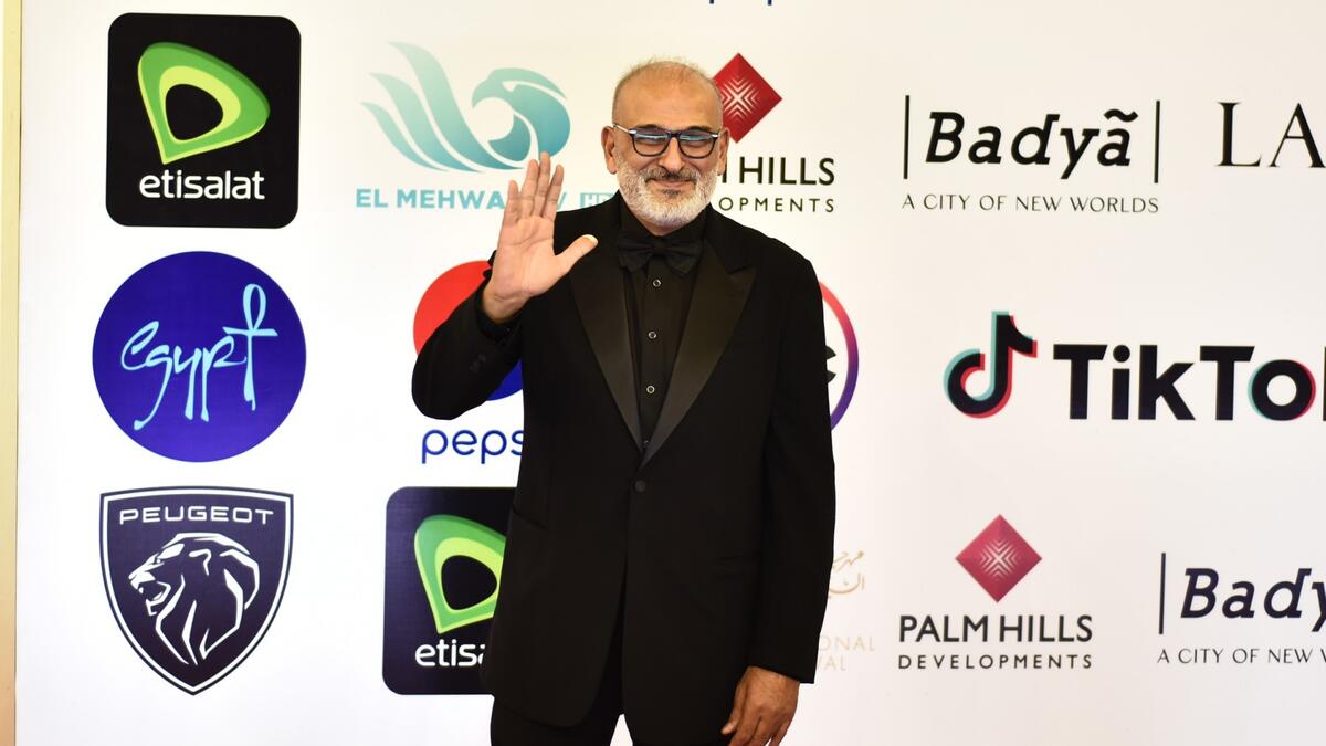 Syrian actor Jamal Suleiman poses on the red carpet during the opening of the 43rd edition of the Cairo International Film Festival (CIFF) at the Cairo Opera House in the Egyptian capital on November 26, 2021. (Photo by Sayed HASAN / AFP)
