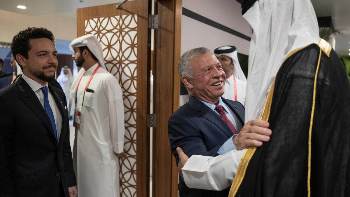 Qatar's Emir Sheikh Tamim bin Hamad al-Thani (R) welcoming King Abdullah II (C) and his son Crown Prince Al Hussein, ahead of the opening of the Qatar 2022 World Cup football tournament in Doha, on November 20, 2022.