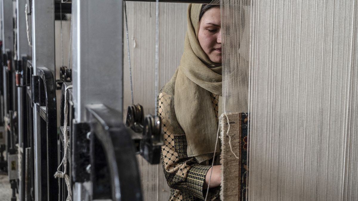 Afghan women weave carpets at a factory on the outskirts of Kabul. Many women have launched small businesses in the past three years to meet their own needs and support other Afghan women (Photo by AFP)