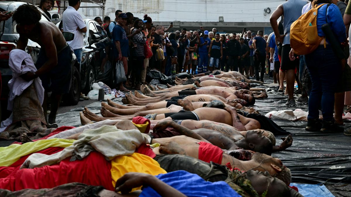 People line up bodies on Sao Lucas Square of the Vila Cruzeiro favela at the Penha complex in Rio de Janeiro, Brazil, on October 29, 2025, in the aftermath of Operacao Contencao (Operation Containment). AFP Death toll in Brazil’s Rio police raid rises to 132
