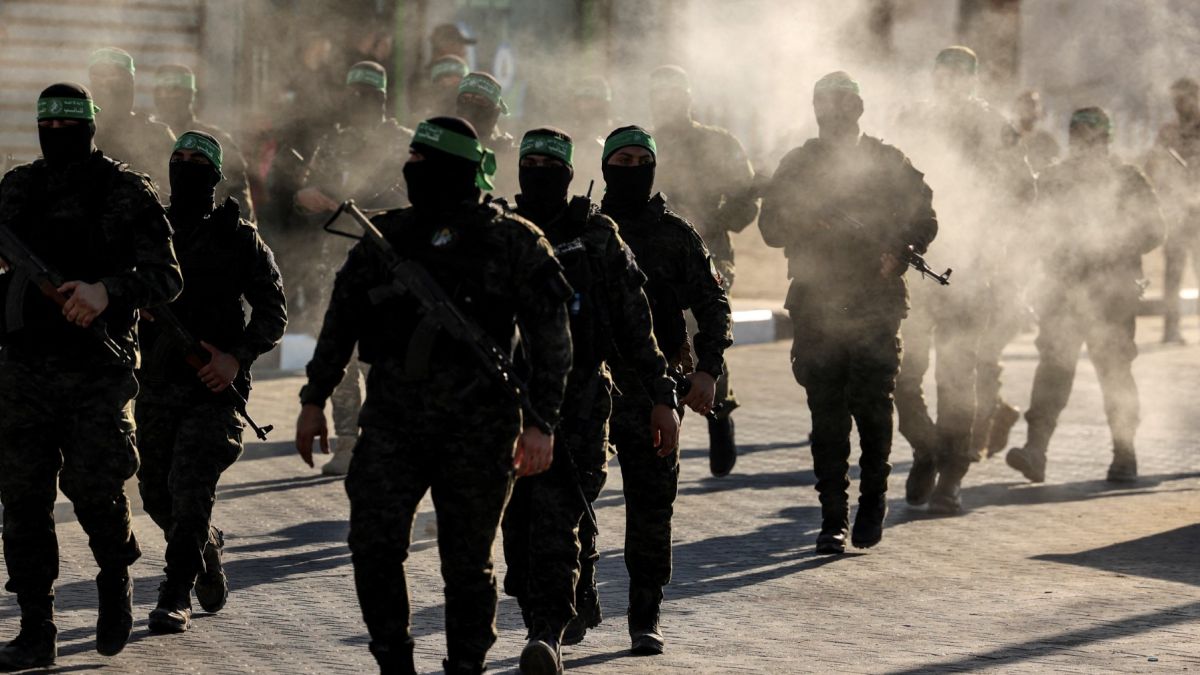 Masked members of the al-Qassam Brigades, the military wing of Hamas, march during a rally in Gaza City on July 20, 2022. (Photo by Mahmud HAMS / AFP) New era for Gaza: Independent technocrats to take the helm after faction deal
