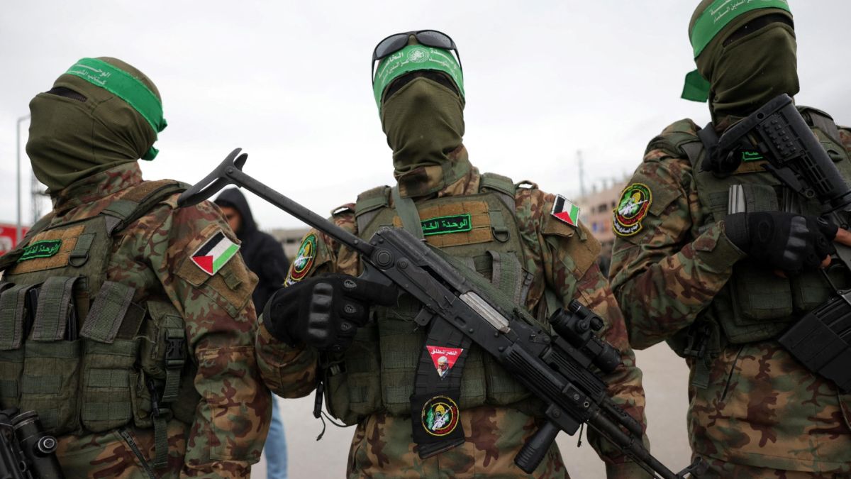 Palestinian Hamas fighters gather at the site of the handing over of Israeli hostages at the Nuseirat refugee camp in the central Gaza Strip as part of the seventh hostage-prisoner release on February 22, 2025. Photo by BASHAR TALEB / AFP Palestinian Hamas fighters