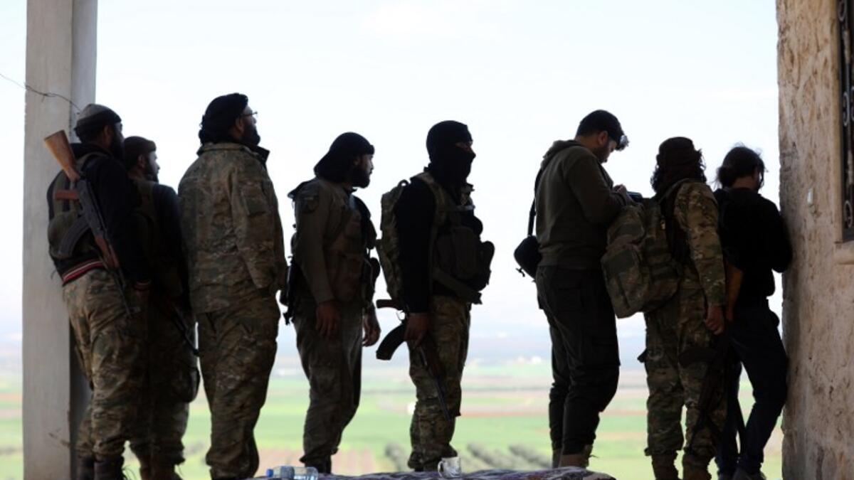 Turkish-backed Syrian rebels gather in the town of Jalamah on the Syrian-Turkish border on Mar. 12, 2018. 
(OMAR HAJ KADOUR / AFP)