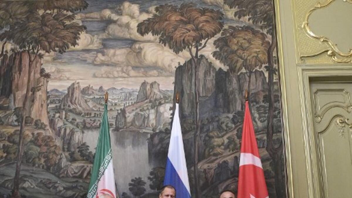 Russian Foreign Minister Sergei Lavrov (C), his Turkish counterpart Mevlut Cavusoglu (R) and Iran's Foreign Minister Mohammad Javad Zarif pose for pictures prior to their meeting in Moscow on April 28, 2018.  Alexander NEMENOV / AFP