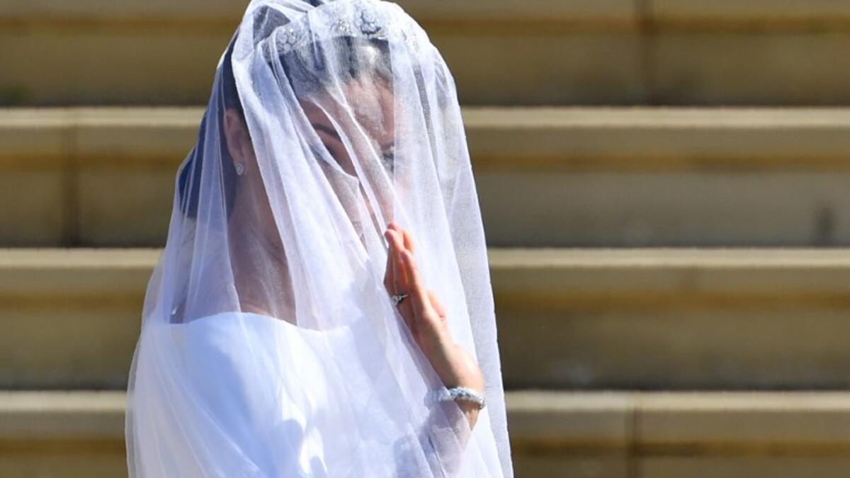 US actress Meghan Markle waves as she arrives for the wedding ceremony to marry Britain's Prince Harry, Duke of Sussex, at St George's Chapel, Windsor Castle, in Windsor, on May 19, 2018. 
Ben STANSALL/ AFP