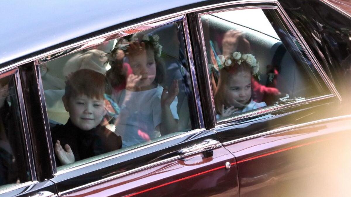 Prince Harry's niece and bridesmaid Princess Charlotte (R) arrives for the wedding ceremony of Britain's Prince Harry, Duke of Sussex and US actress Meghan Markle at St George's Chapel, Windsor Castle, in Windsor, on May 19, 2018. 
Andrew Matthew/ AFP
