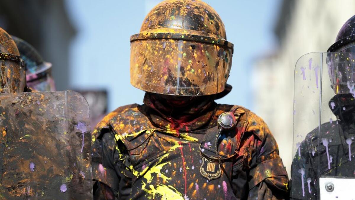 Catalan regional police 'Mossos D'Esquadra' officers covered in paint stand guard after clashing with separatist protesters during a counter-protest against a demonstration in support of Spanish police in Barcelona on September 29, 2018. 
Pau Barrena / AFP