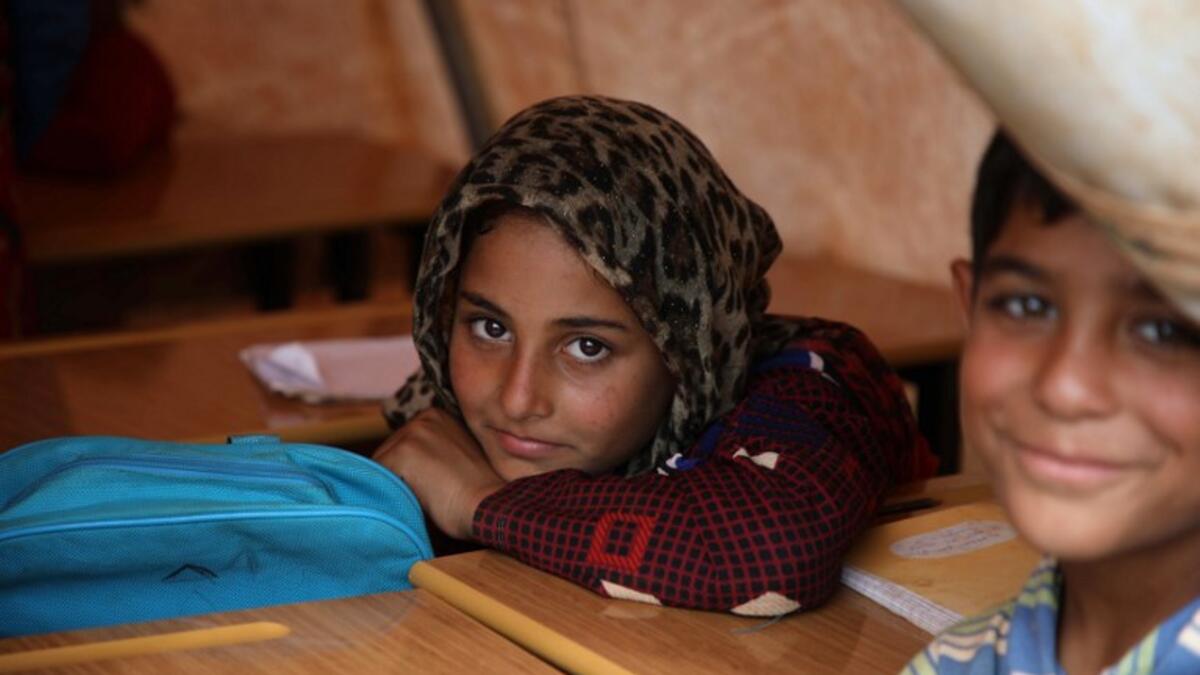 Syrian children who fled with their families from the northern countryside of Hama, are pictured in a classoom at the makeshift school of "Zuhur al-Mustaqbal"  Aaref WATAD / AFP