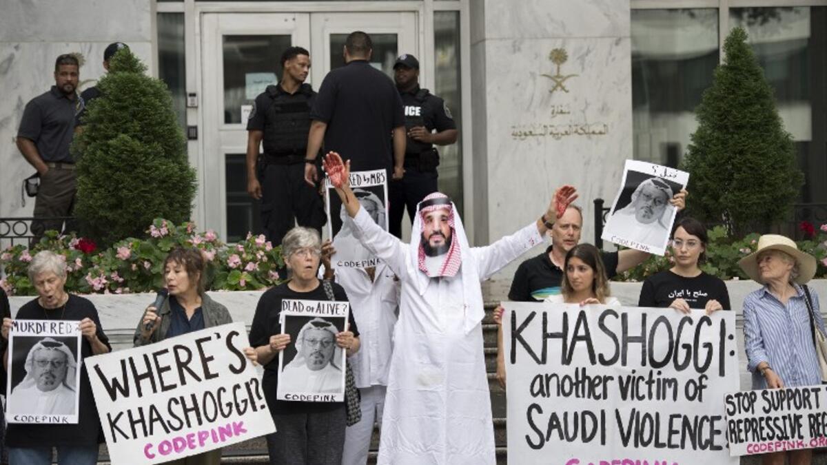 A demonstrator dressed as Saudi Arabian Crown Prince Mohammed bin Salman (C) with blood on his hands protests with others outside the Saudi Embassy in Washington, DC. (Jim WATSON / AFP)