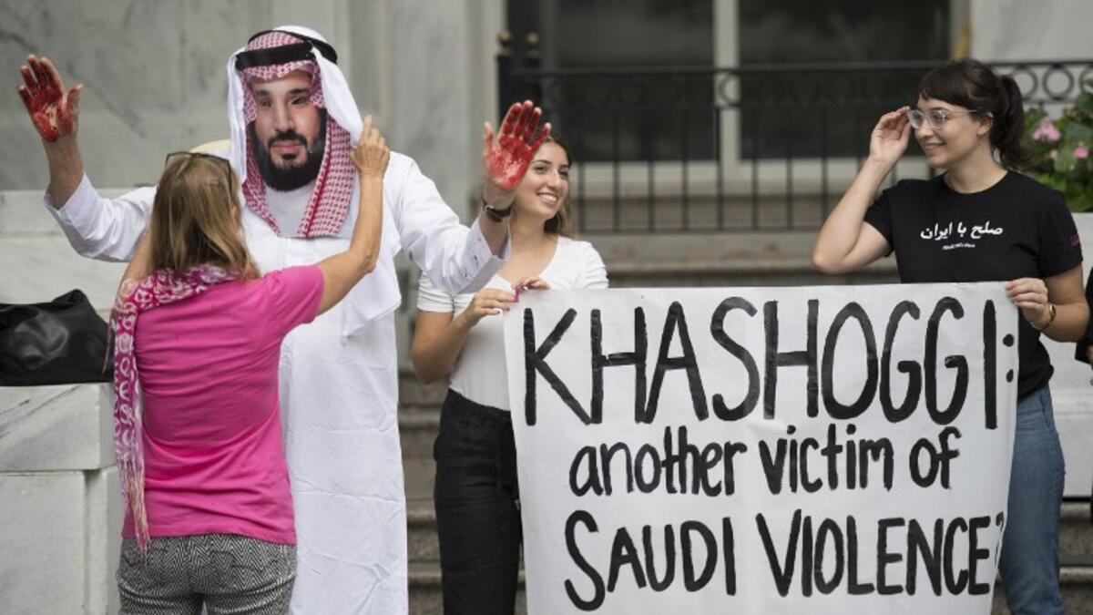 A demonstrator dressed as Saudi Arabian Crown Prince Mohammed bin Salman (C) with blood on his hands protests with others outside the Saudi Embassy in Washington, DC. (Jim WATSON / AFP)