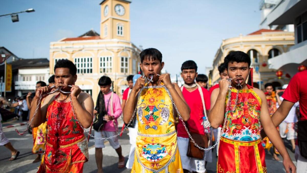 Devotees of the Loem Hu Thai Su shrine parade during the annual Vegetarian Festival in Phuket on October 12, 2018. Jewel SAMAD/AFP