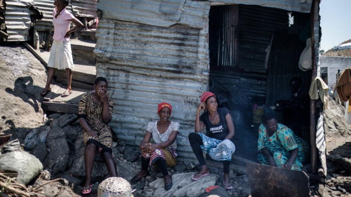 Women gather together on Migingo island on October 5, 2018 which is densely populated by residents fishing mainly for Nile perch in Lake Victoria on the border of Uganda and Kenya. 
Yasuyoshi CHIBA / AFP