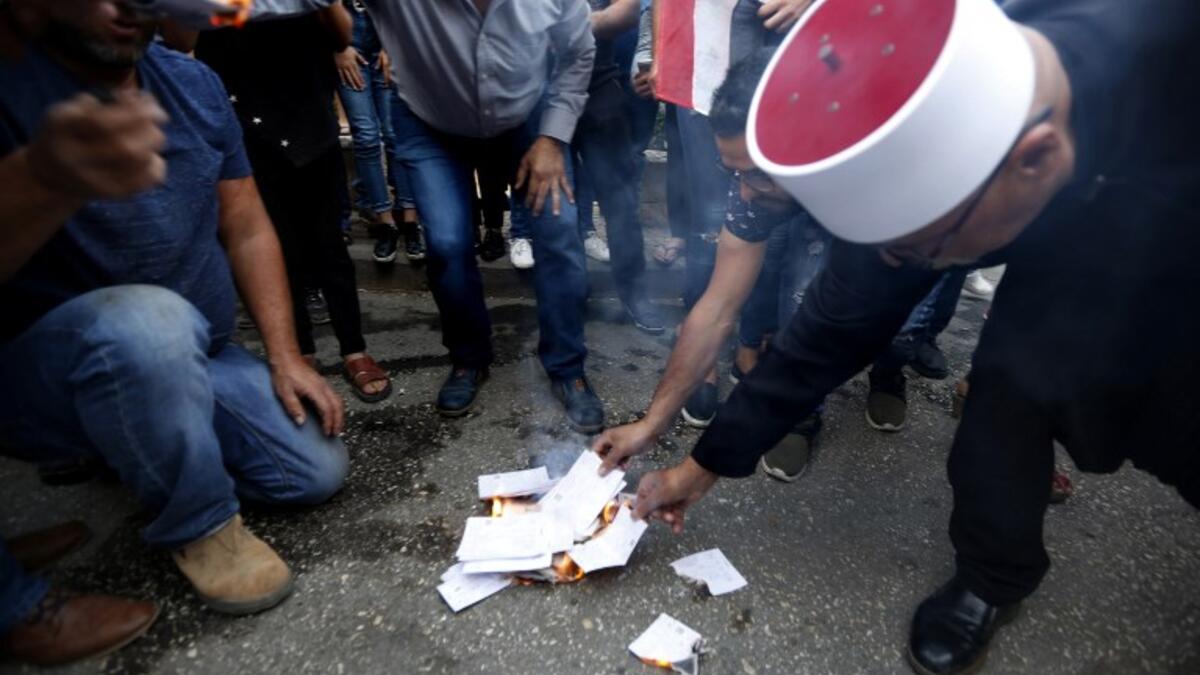 Druze residents of Majdal Shams in the Israeli-annexed Golan Heights set ablaze makeshift ballot papers during a protest on October 19, 2018. (JALAA MAREY / AFP)