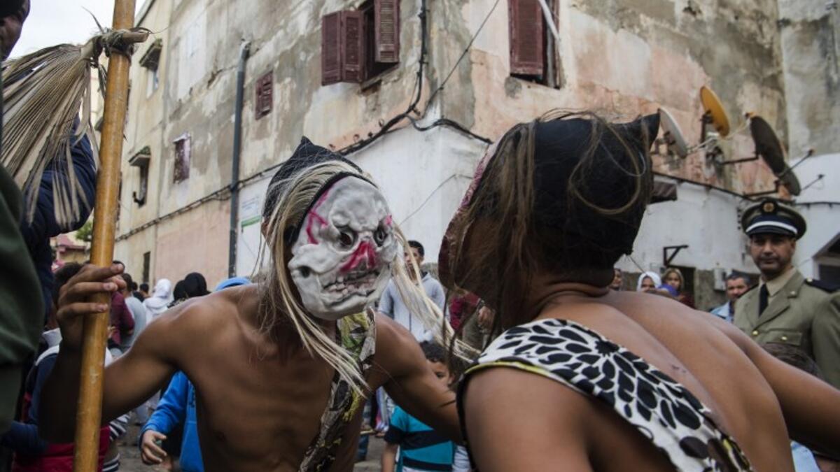 Young Moroccans take part in the Boujloud festival, a popular celebration also known as the 'Moroccan Halloween' in the Sidi Moussa district of Sale near Rabat, on October 27, 2018. 
FADEL SENNA / AFP