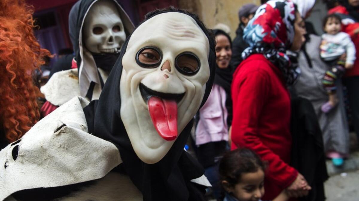 Young Moroccans take part in the Boujloud festival, a popular celebration also known as the 'Moroccan Halloween' in the Sidi Moussa district of Sale near Rabat, on October 27, 2018. 
FADEL SENNA / AFP