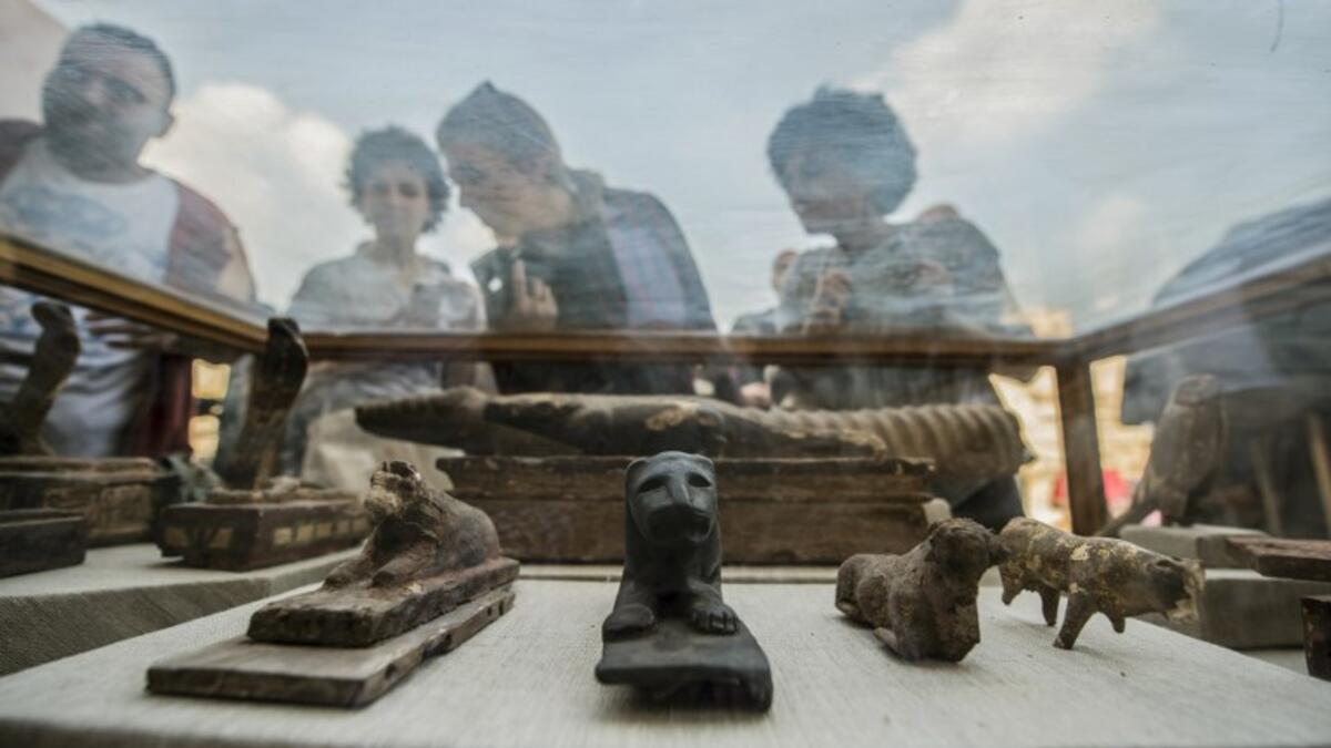 Diplomats and other viewers look at monuments displayed during a new discovery made by an Egyptian archaeological mission. (KHALED DESOUKI / AFP)