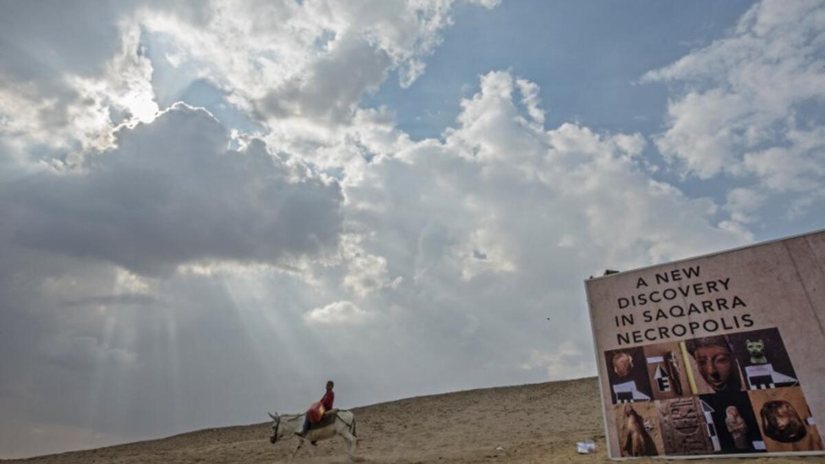 A boy rides a donkey near a new discovery made by an Egyptian archaeological mission. (KHALED DESOUKI / AFP)