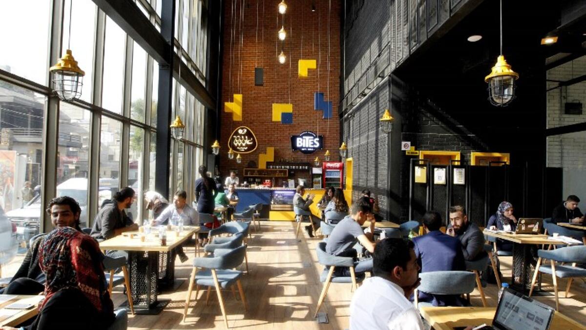 Iraqis sit at "The Station", Baghdad's incubator for would-be entrepreneurs, in the Iraqi capital on November 17, 2018. 
SABAH ARAR / AFP