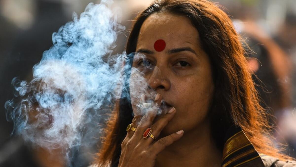 A member of the Indian transgender community smokes a cigarette as she protests against the Transgender Persons (Protection of Rights) Bill in New Delhi on December 28, 2018. 
CHANDAN KHANNA / AFP