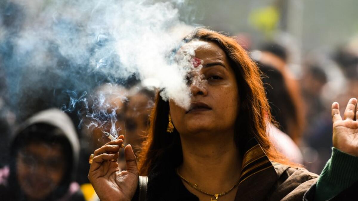 A member of the Indian transgender community smokes a cigarette as she protests against the Transgender Persons (Protection of Rights) Bill.
CHANDAN KHANNA / AFP