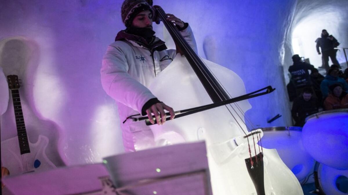 A musician performs with an ice violin during a concert in the "Ice Dome" on Presena Galcier, Tonale Pass, near Trento in northern Italy on January 17, 2018. 
Marco BERTORELLO / AFP