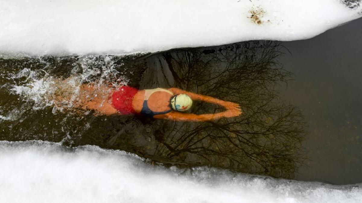 Natalya Seraya, the founder and chief of Moscow's ice swimming club "Walruses of the Capital", swims in a strip of water cut in the ice by the bank of the Moscow River on February 3, 2019. 
Kirill KUDRYAVTSEV / AFP