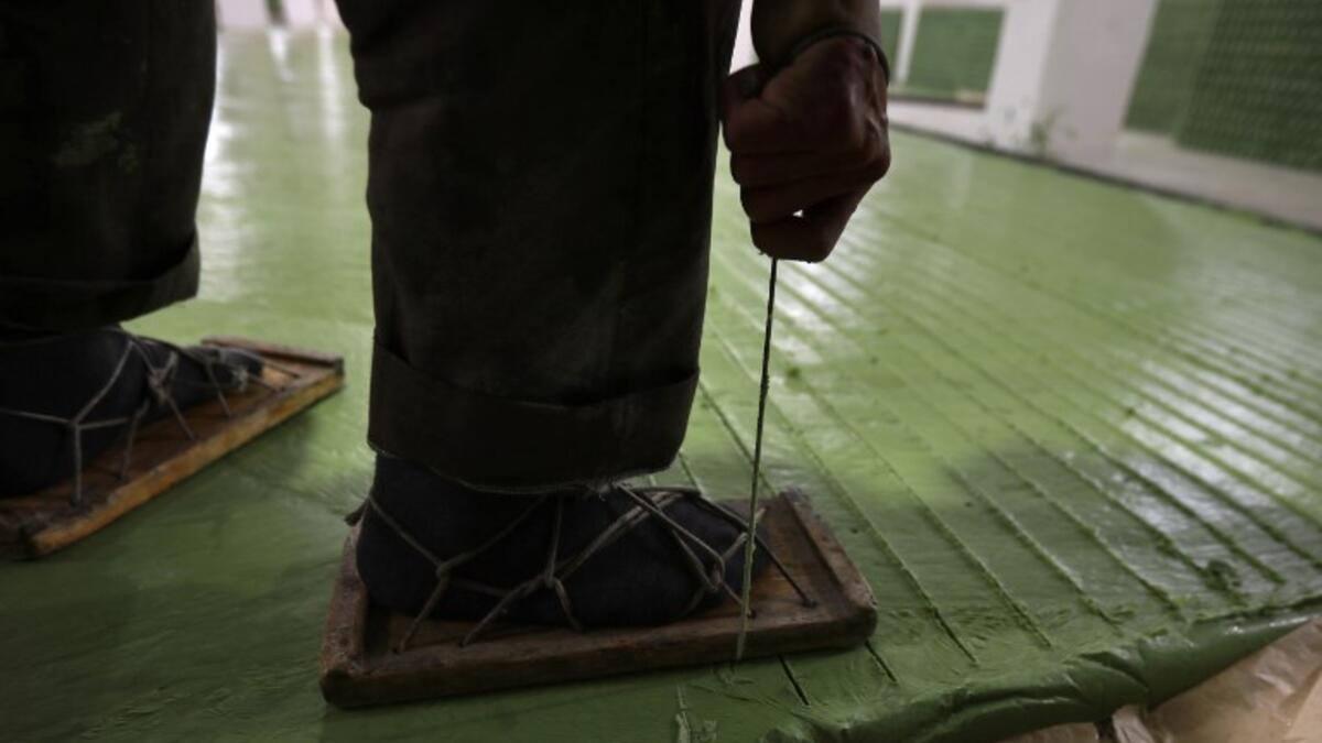 A Syrian worker cuts olive soap bars in a factory on the outskirts of Aleppo 
LOUAI BESHARA / AFP