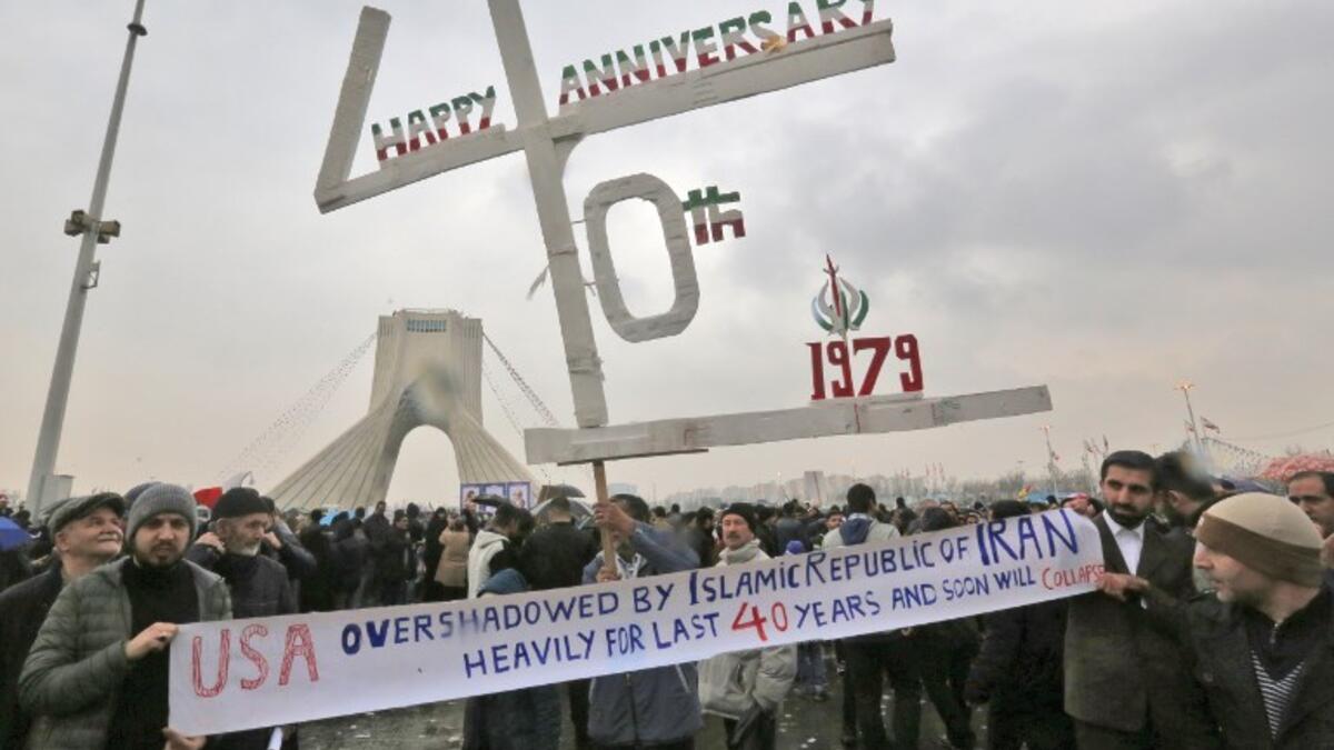 Iranians pose for a picture as they assemble with others in the capital Tehran's Azadi (Freedom) square on February 11, 2019 during a ceremony celebrating the 40th anniversary of Islamic Revolution. 
ATTA KENARE / AFP